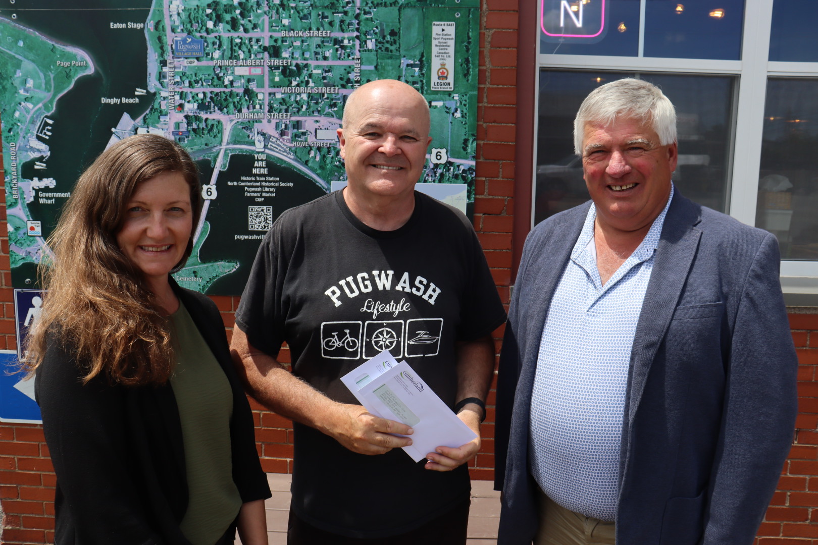 Greg Nix (centre) of the Cumberland Trails Association accepts a cheque from Coun. Jennifer Houghtaling and Mayor Rod Gilroy during a presentation event on Tuesday, June 16, in Pugwash. Darrell Cole – Municipality of Cumberland photo